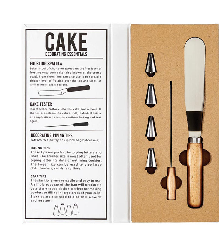 A cake decorating kit displayed on a white background, including a frosting spatula, cake tester, and various decorating tips.
